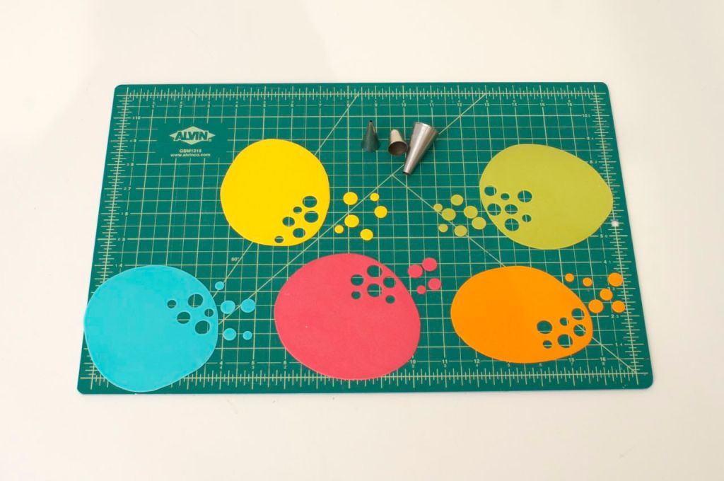 To make confetti, roll out sugar paste and cut out circles using piping tips.  Allow to dry.